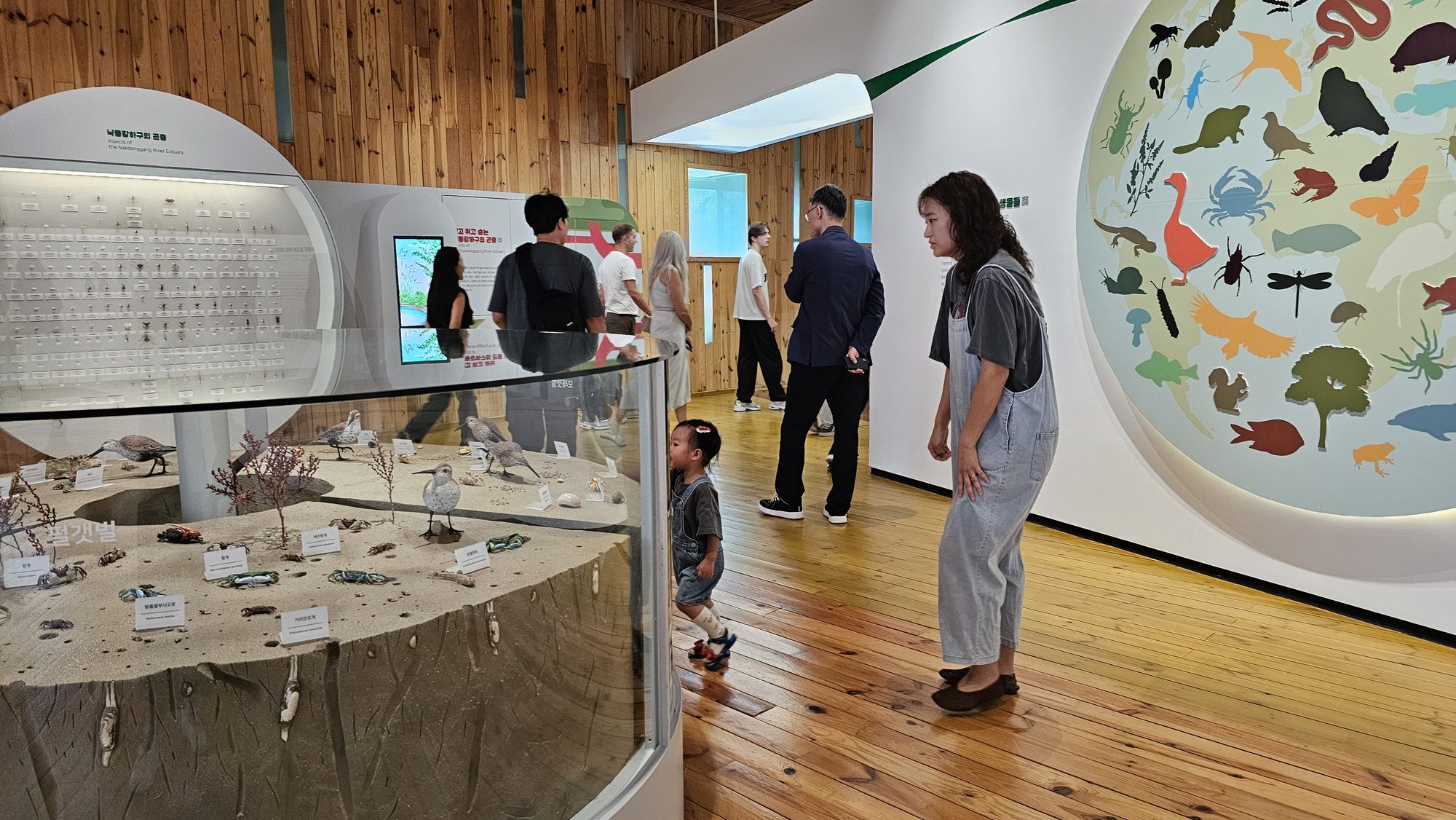A guide walking guests through the wetland's plant and shore-life specimens