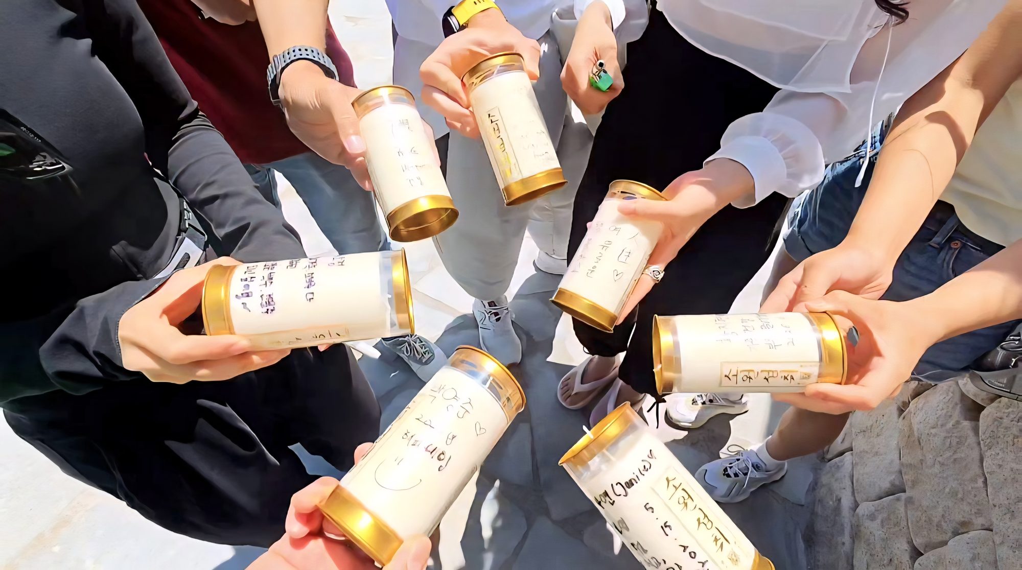Guests holding hand-written wish candles at the closing ritual