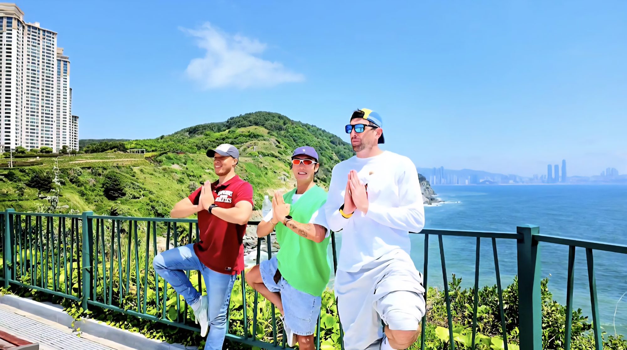 Guests pausing at the skywalk overlook, coastline behind them
