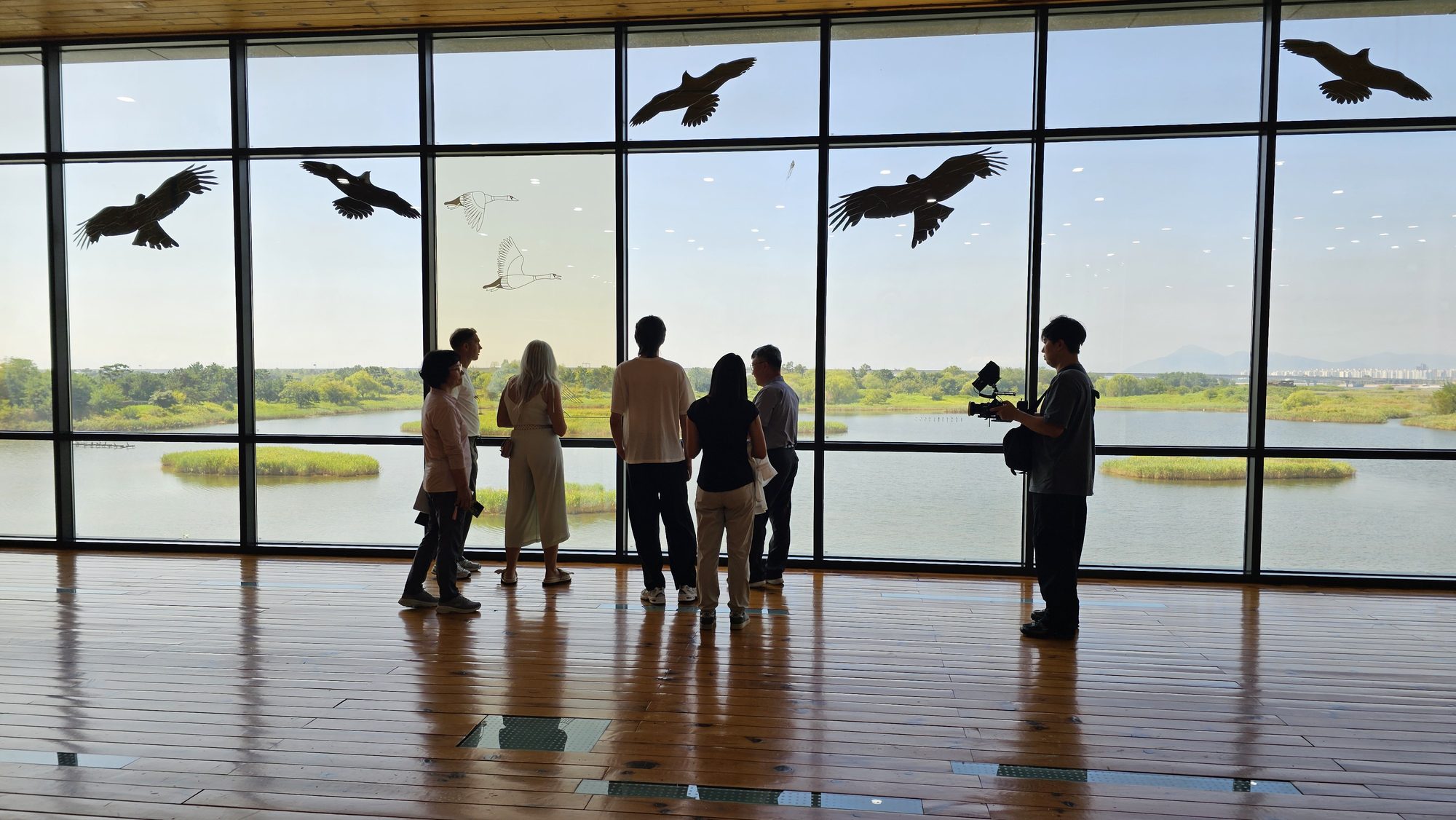 Guests at the Eco Center's panoramic window, overlooking the wetland