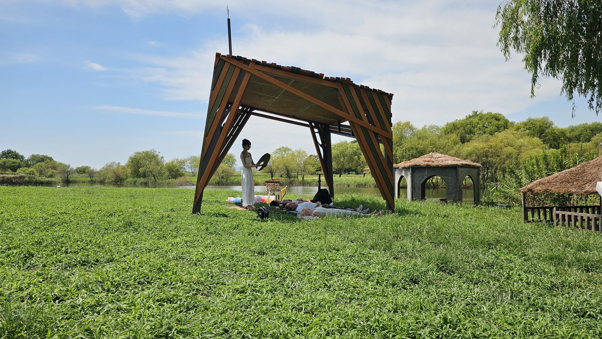 The sound ceremony pavilion beside the wetland at dusk
